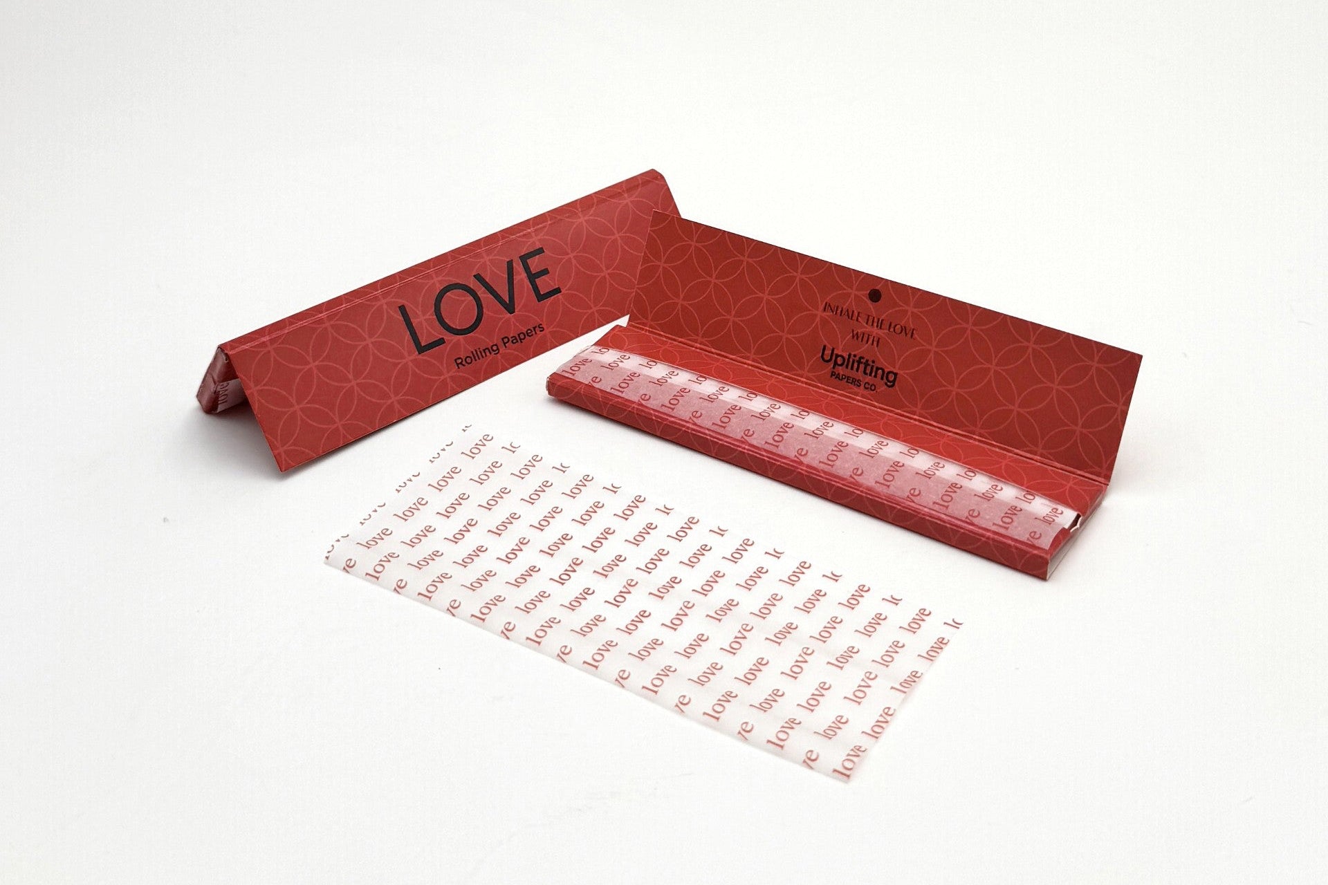 Red box with 'LOVE' text and a sheet of paper on a white background